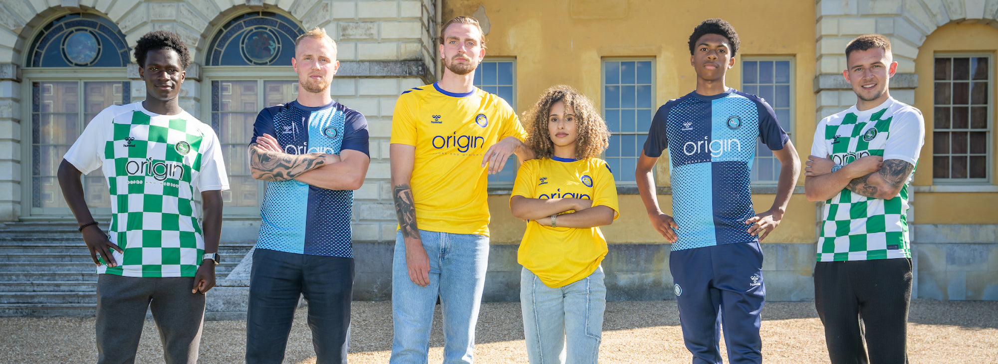Group of people wearing sports jerseys in front of a building
