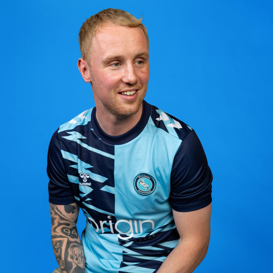 Man wearing a sports jersey with a blue background
